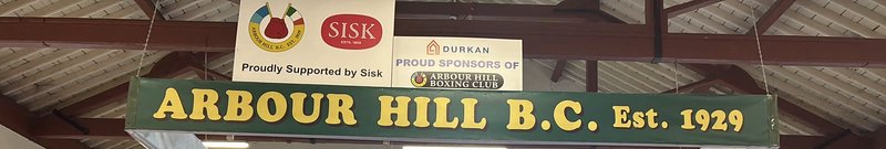 The hall's hand-painted sign: Arbour Hill B.C. Est. 1929