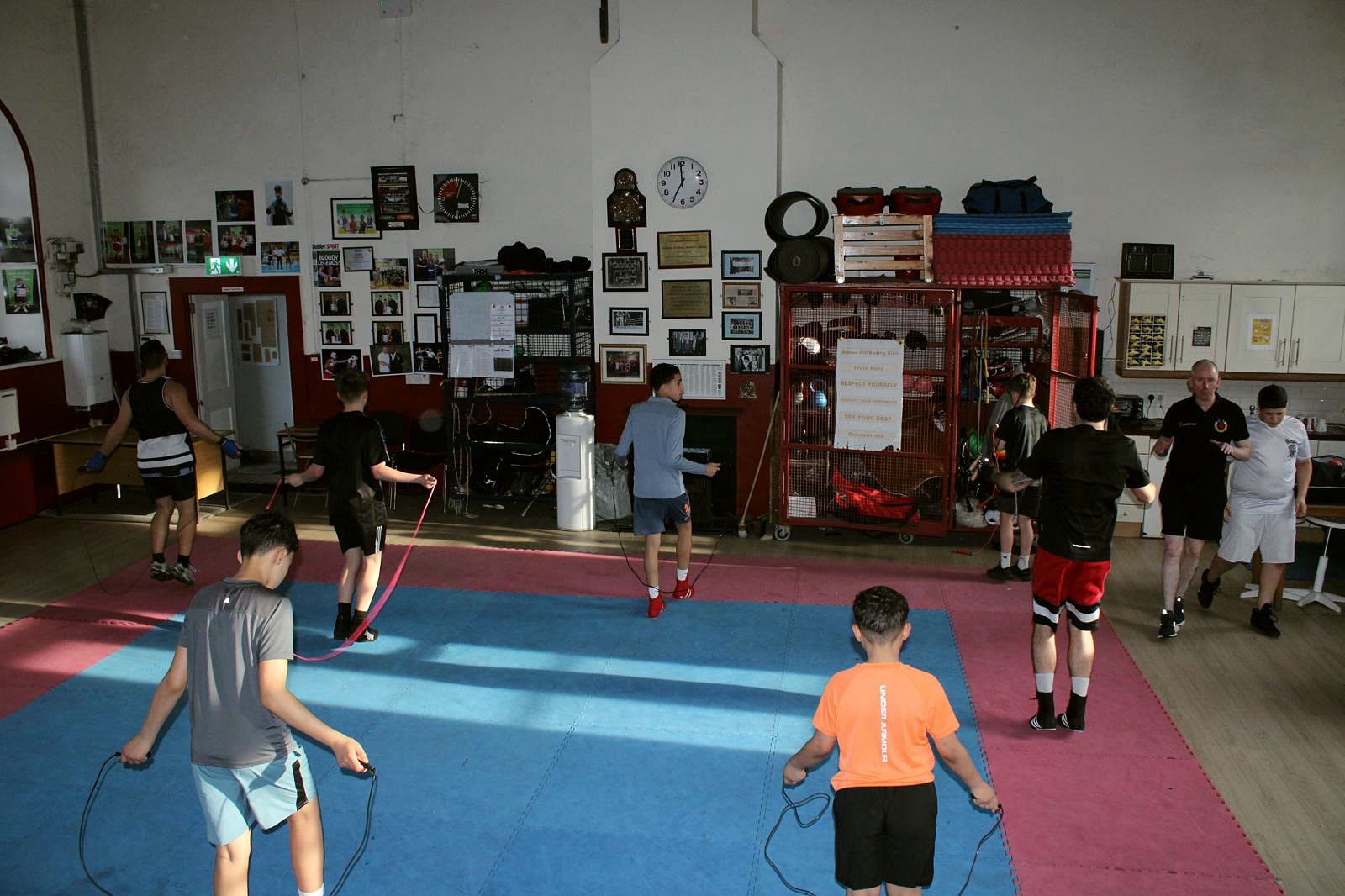 Children skipping on the mats in the Arbour Hill hall, coaches watching from the side